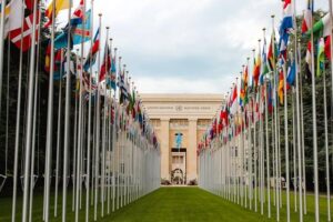 View of the United Nations building with flags from around the world on the right and left to symbolize public sector communications.